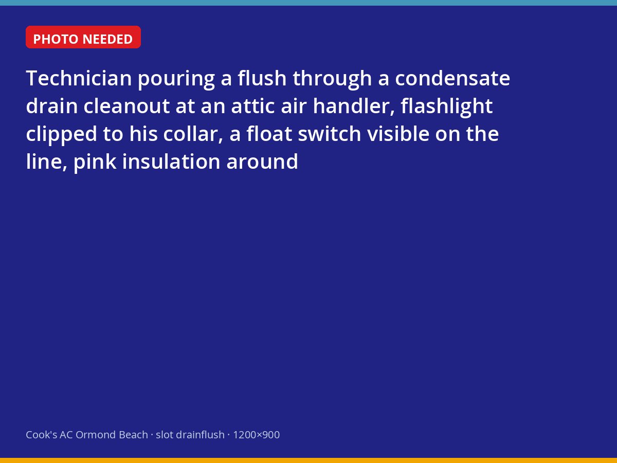 Technician flushing a condensate drain line at an attic air handler